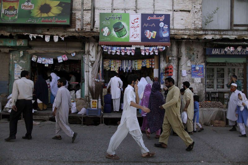 Pakistanis walk past shops in Abbottabad, Pakistan, the city where Osama bin Laden was found and killed earlier this week. The CIA had a safe house in the city and had been spying on the al-Qaida leader.