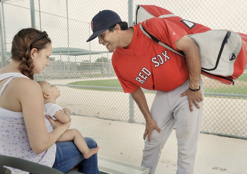 Will Vazquez, right, spends a moment with wife Hannah, and daughter Mia at spring training in Florida in March. He is in a second season as a backup catcher in Portland, where Hannah will celebrate her first Mother’s Day.