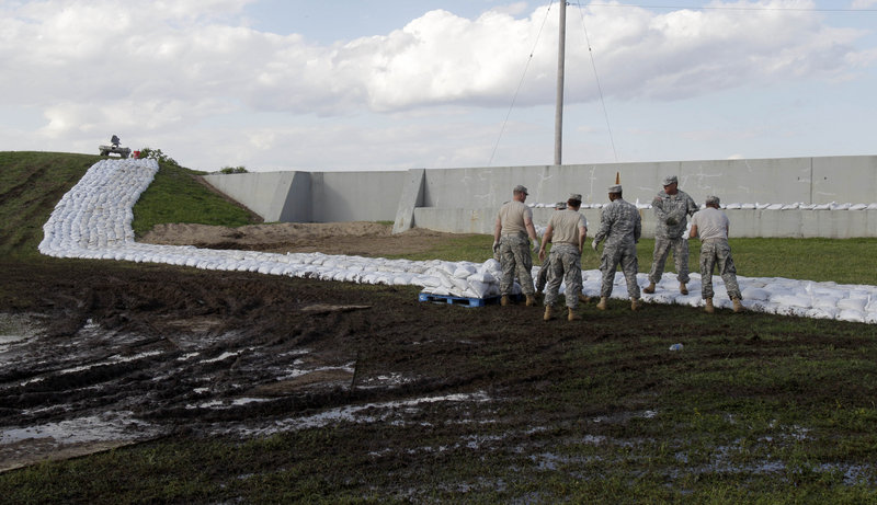 National Guardsmen from Missouri work to construct a temporary sandbag levee in Caruthersville, Mo., earlier this week. Officials hope the secondary levee catches any spillover if the Mississippi River tops the town’s 50-foot flood wall. The forecast calls for a crest of 49.5 feet on Sunday afternoon in the town still recovering from a tornado six years ago.