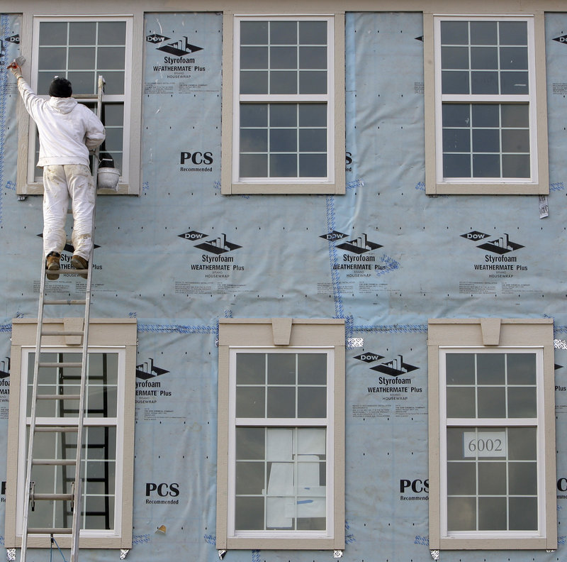 Yuri Kyryk, 25, paints new condominiums Friday in Pepper Pike, Ohio. April was the third straight month in which employers added more than 200,000 jobs.