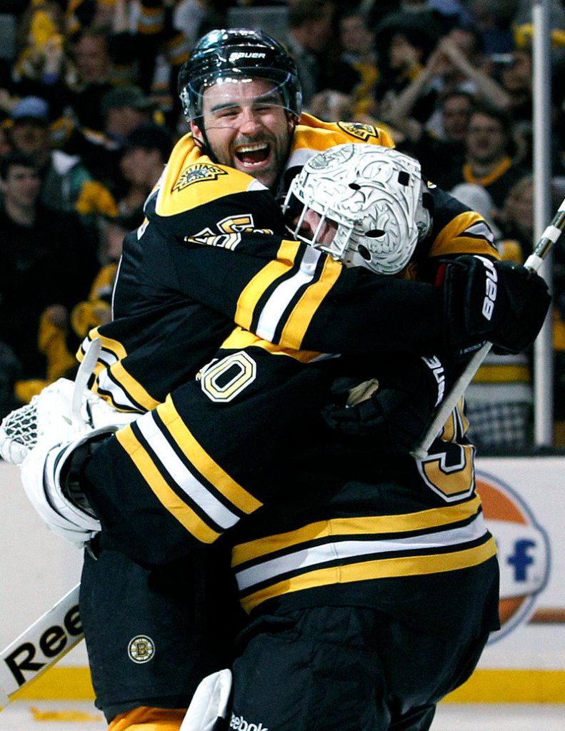Johnny Boychuk celebrates with Bruins goalie Tim Thomas after their 5-1 win over the Flyers on Friday.