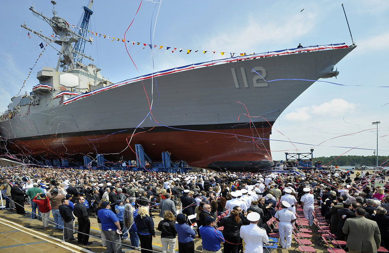 Streamers fly and the crowd applauds after the christening of the Michael Murphy (DDG 112) Saturday at Bath Iron Works. Fabrication of the warship began in September 2007, a month before Maureen Murphy accepted the Medal of Honor for her son.