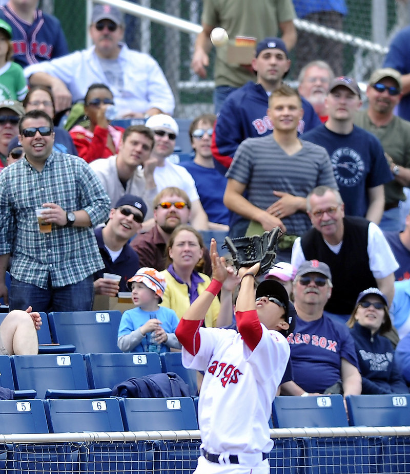 Jonathan Hee of the Portland Sea Dogs delights the crowd Saturday while catching a foul pop in front of the third-base railing. It was a delightful day for the Dogs at Hadlock Field – four home runs in a 15-7 win over New Britain.