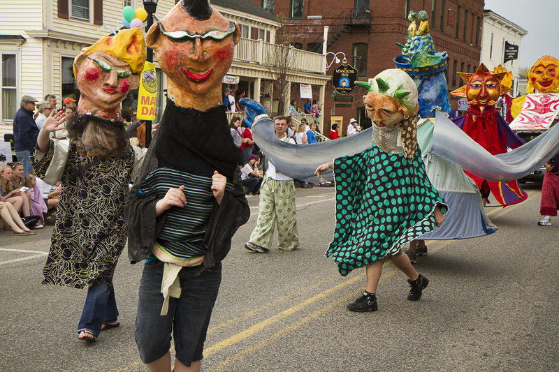 Human puppets from Shoestring dance their way down Main Street.