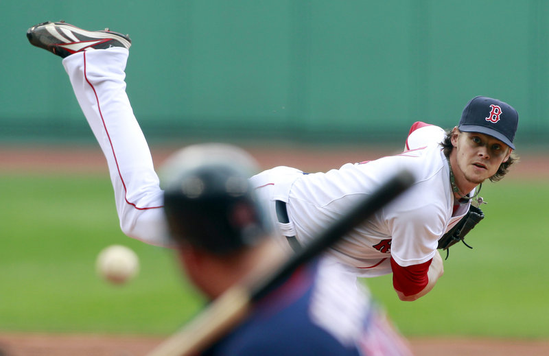 Clay Buchholz pitches during the first inning of Saturday’s game with Minnesota in Boston. Buchholz pitched two innings, then waited out a rain delay of more than two hours before pitching three more innings in a 4-0 Sox win.