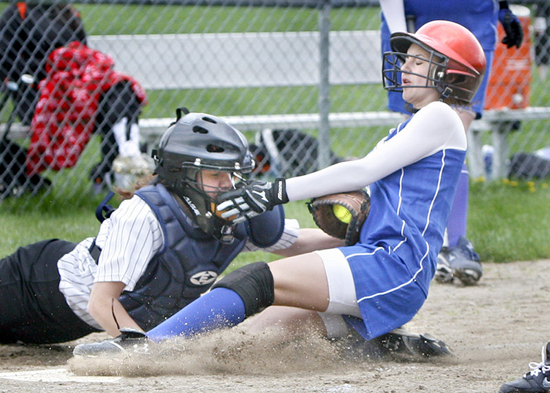 Chelsey Burnell of Sacopee Valley slides under a tag applied by Savanna Poole of North Yarmouth Academy to score Saturday during their Western Maine Conference doubleheader at Yarmouth. Sacopee Valley remained undefeated by winning both games.