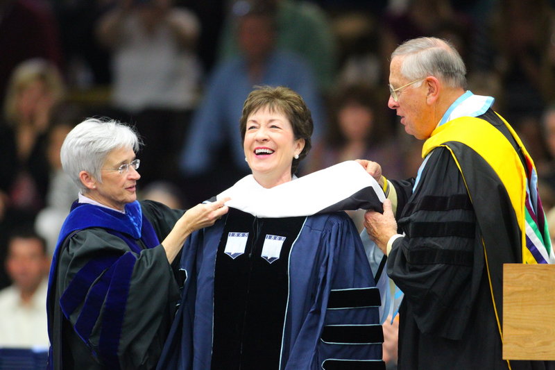 University of Maine Provost Susan Hunter, left, and Trustee William Johnson, right, confer an honorary doctorate upon U.S. Sen. Susan Collins at commencement ceremonies Saturday in Orono. In her address, Collins encouraged graduates to "apply (their) talent .... right here in (Maine)."