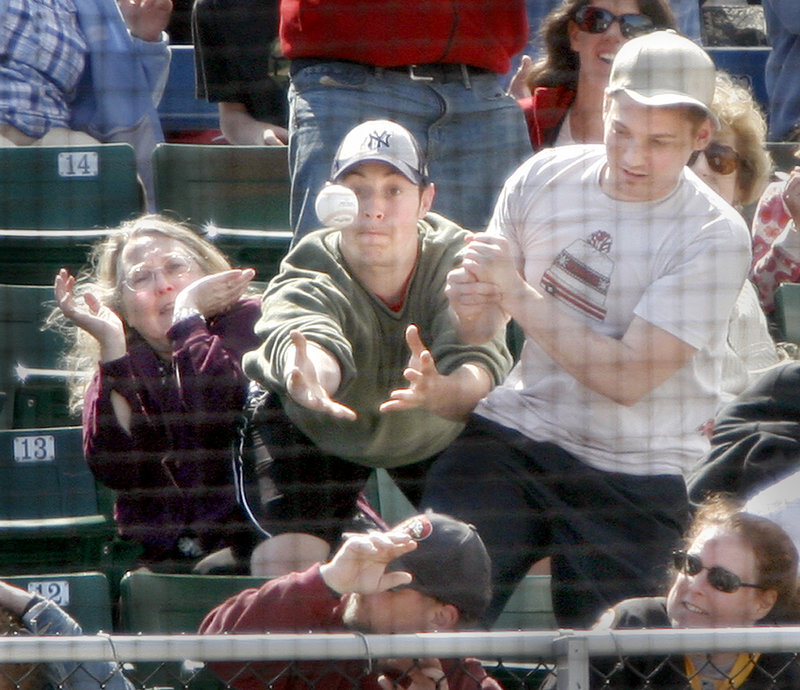 A fan unsuccessfully tries to catch a foul ball during Sunday's game at Hadlock Field between the Portland Sea Dogs and New Britain Rock Cats. The Sea Dogs fell to 3-5 this season against New Britain.