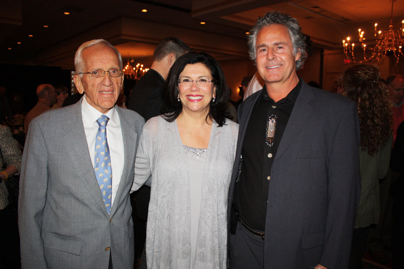 T. Colin Campbell, left, with Barbara Gulino, marketing leader at Whole Foods Market, where Campbell signed books earlier in the day, and Dr. John Herzog at the Mercy Hospital banquet where Campbell spoke last week.