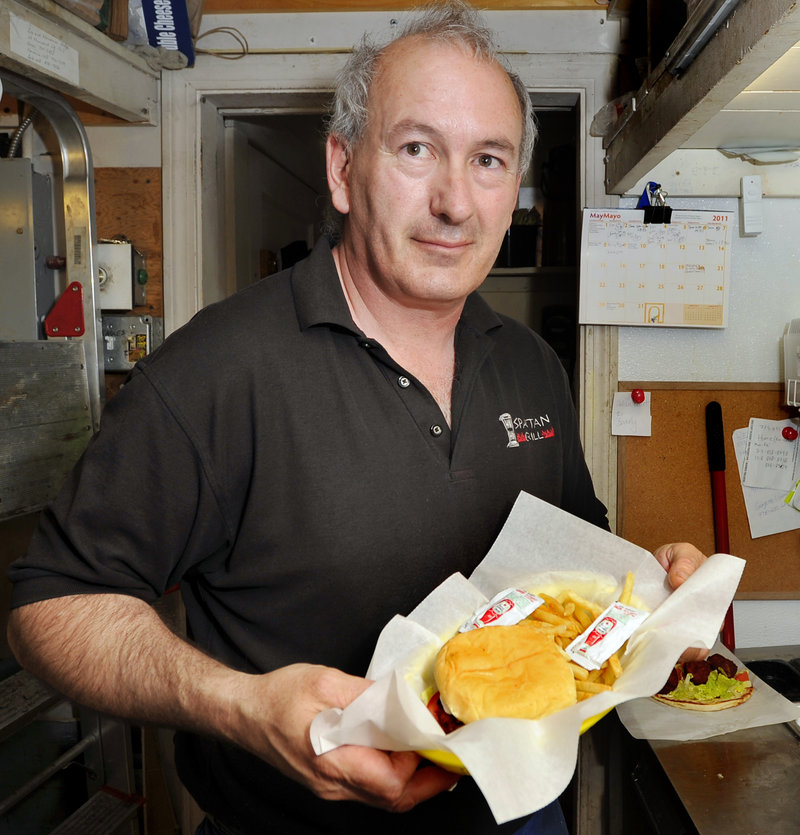Mike Roylos shows off a Falafal Burger Basket at Spartan Grill and Coffee.