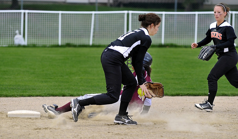 Thornton’s Kristen Duross slides safely into second base as Biddeford shortstop Katelyn LeBreux, foreground, can’t hold onto the ball. Biddeford teammate Kristine McCurry backs up the play.