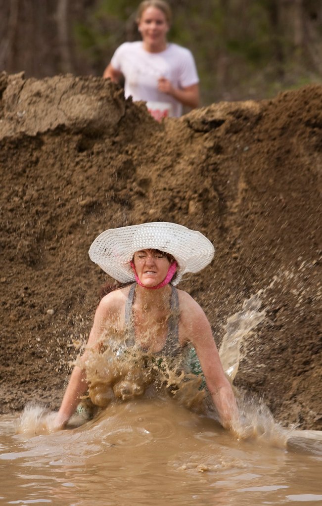 Allison Caney plunges into the mud near Gorham Middle School during last weekend’s Mud Run.