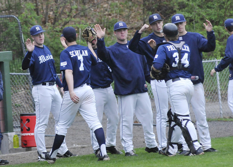 Pitcher Kevin Scanlan, 7, and catcher Tyler Patzalek are greeted by teammates on the way to the Maine dugout at the end of an inning. Scanlan went five innings but was not involved in the decision as Maine rallied in the ninth inning to beat Northeastern, 5-2.