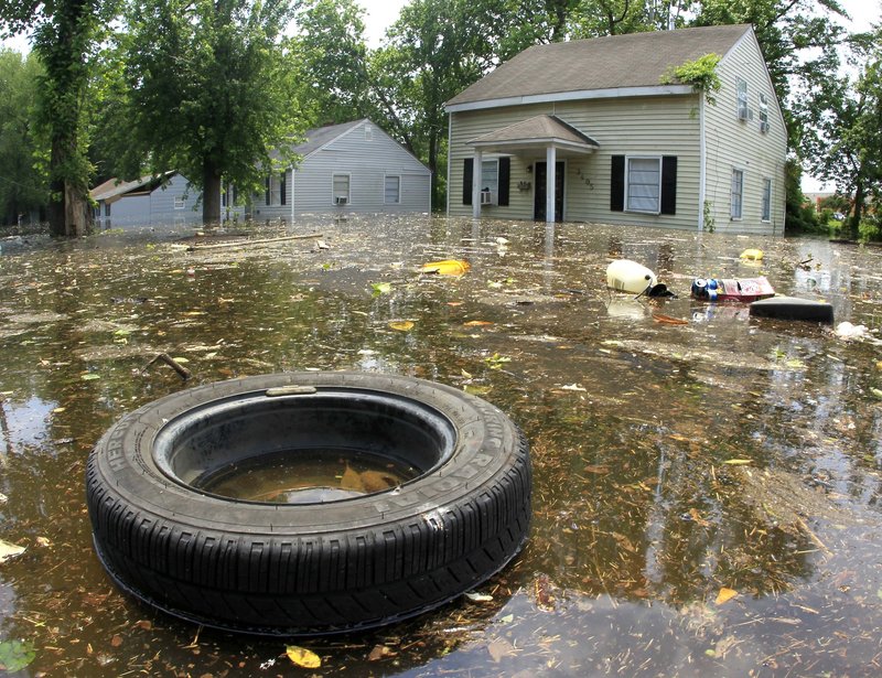 A tire and other debris floats by flooded homes in Memphis. As the floodwaters headed south, the river level was expected to hold just below 48 feet in Memphis.