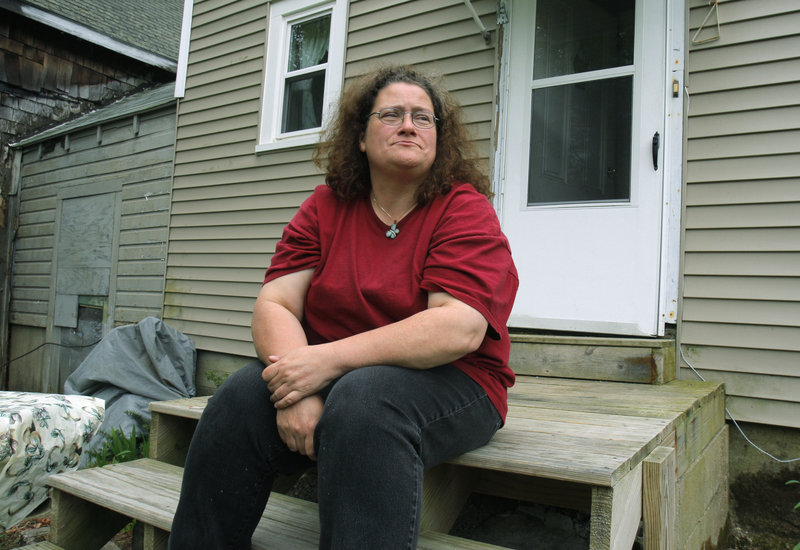 Donna Petelis sits on her stoop in Ossipee, N.H.