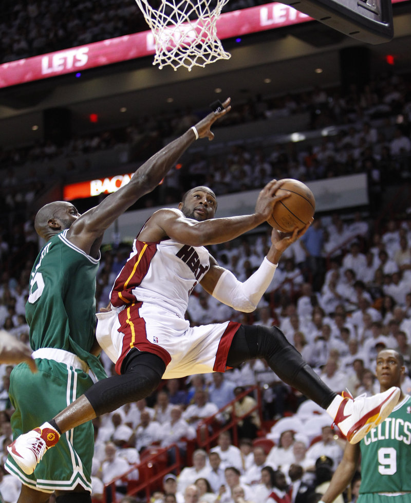 Dwyane Wade, who scored 34 points Wednesday night, drives ahead of Kevin Garnett of the Boston Celtics during the Miami Heat’s 97-87 victory that ended the series.