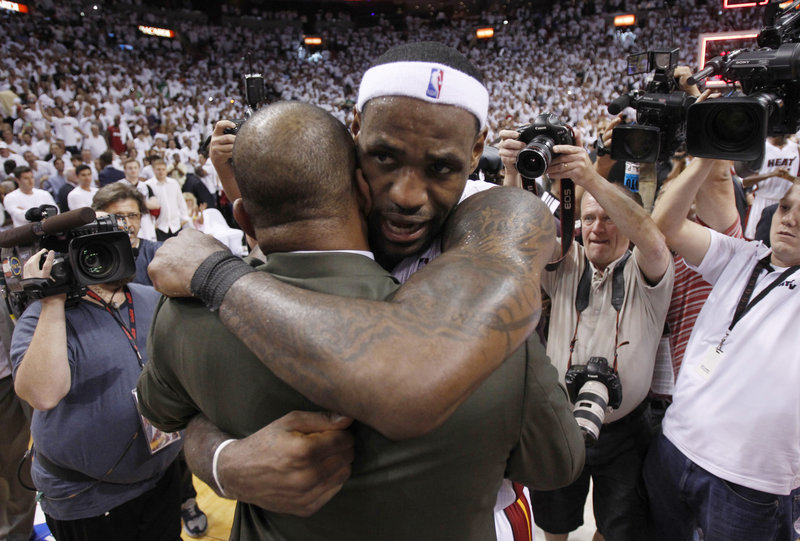 LeBron James hugs Celtics Coach Doc Rivers, who said after the loss Wednesday night that he plans to return next season.