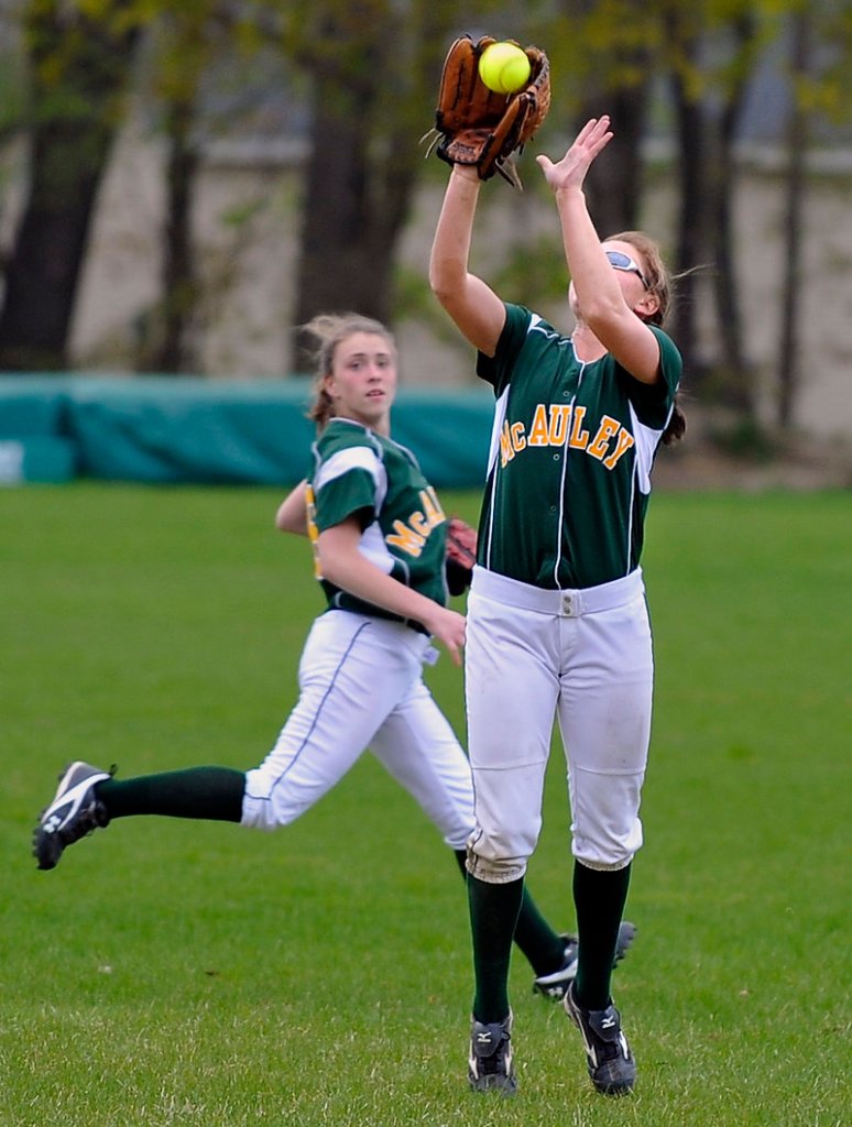 Top pic: Center fielder Shellby Bryant, right, of McAuley, makes a catch as left fielder Sam Libby backs up the play during Wednesday's game, a 4-3 McAuley win over Noble.
