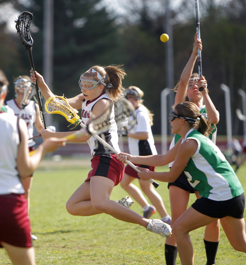 Kaitlyn SeeHusen of Gorham trips while trying to make her way through the Massabesic defenders. Gorham reached 8-0 while dropping Massabesic to 3-3.