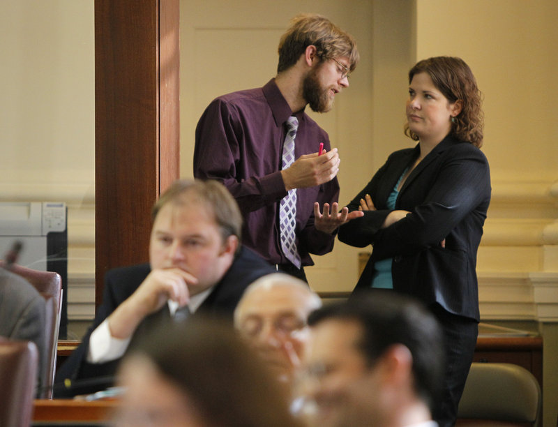 State Rep. Adam Goode, D-Bangor, and House Democratic leader Emily Cain, D-Orono, confer Thursday during a debate on a health care bill at the State House in Augusta. Republicans, who have a narrow majority in the House, rejected six amendments offered up by Democrats in the chamber.