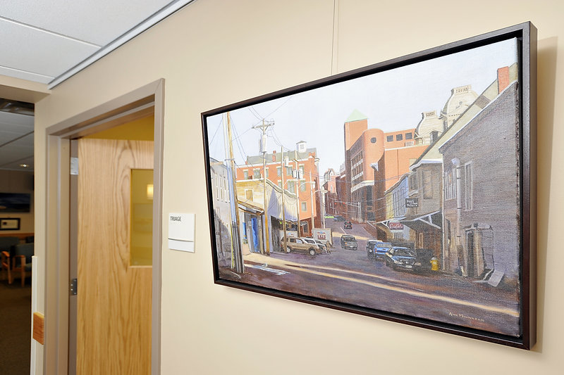 An Ann Mohnkern painting of Portland’s Custom House Wharf hangs in the new health-care center in Yarmouth. Works by another artist will go up in mid-June.