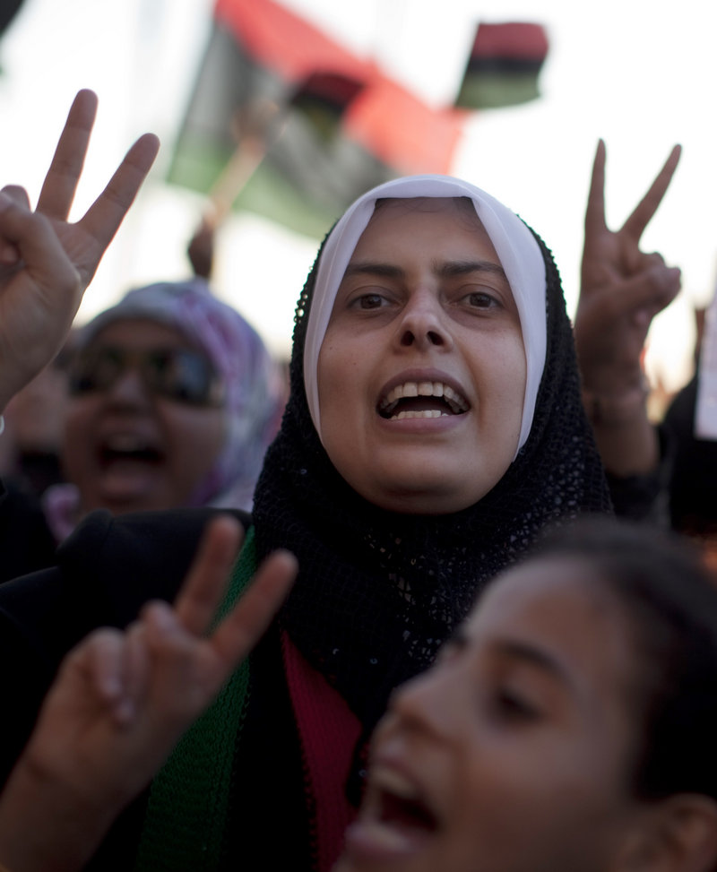 Women chant anti-Moammar Gadhafi slogans during a protest in Benghazi, Libya, on Friday. Gadhafi said in an audio recording played on Libyan TV that he is still alive despite NATO airstrikes.