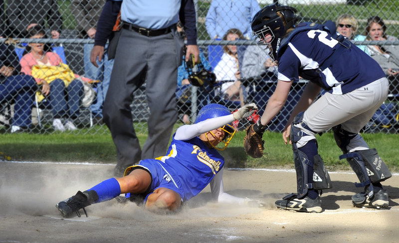 Jessie L’Heureux of Falmouth slides into the plate in the fifth inning in front of Yarmouth catcher Julie Dursema during their Western Maine Conference softball game at Falmouth. L’Heureux also had a run-scoring triple during a 4-3 victory.