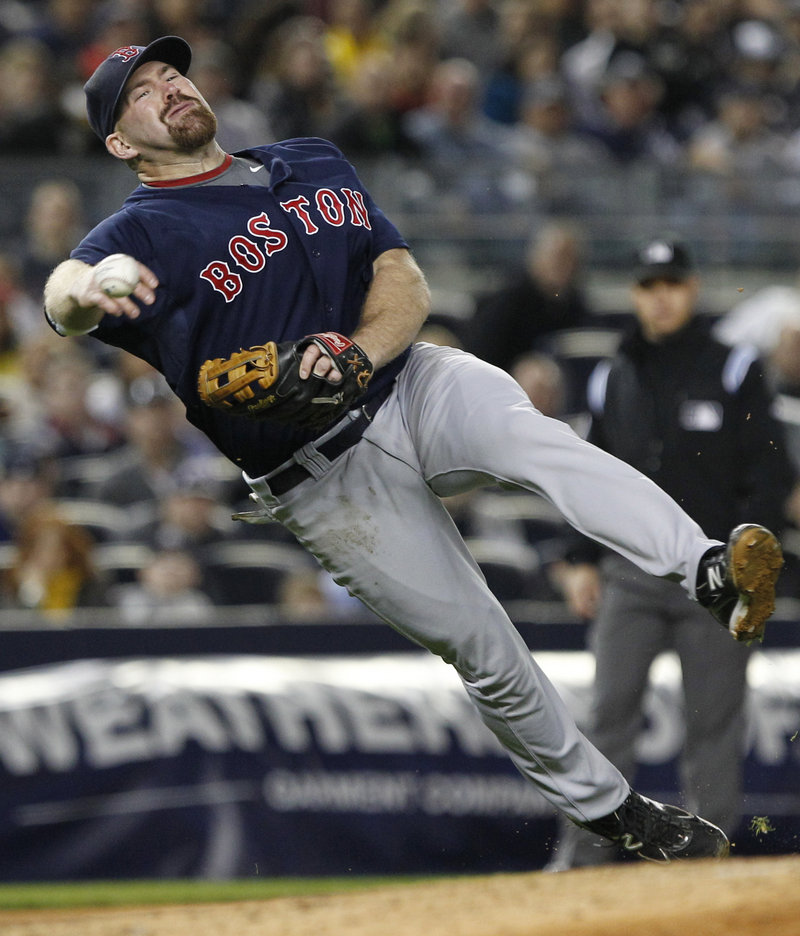 Kevin Youkilis of the Red Sox controls his body and whips a throw from third base in time to get Robinson Cano of the New York Yankees in the sixth inning of Boston’s 5-4 victory Friday night.