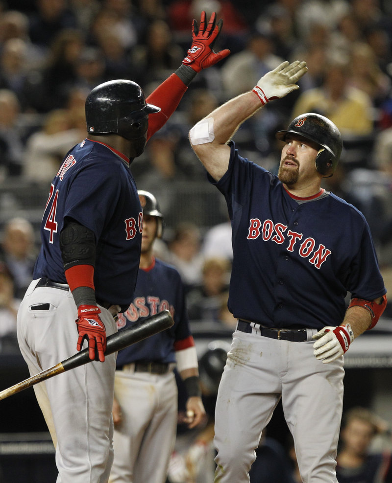 Kevin Youkilis, right, of the Red Sox celebrates with David Ortiz after hitting a two-run homer in the seventh inning Friday night en route to a 5-4 victory against the New York Yankees. Boston moved within two games of .500.
