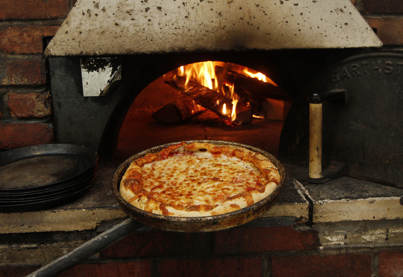 A pizza emerges from Dimitri's oven at the Scarborough eatery.