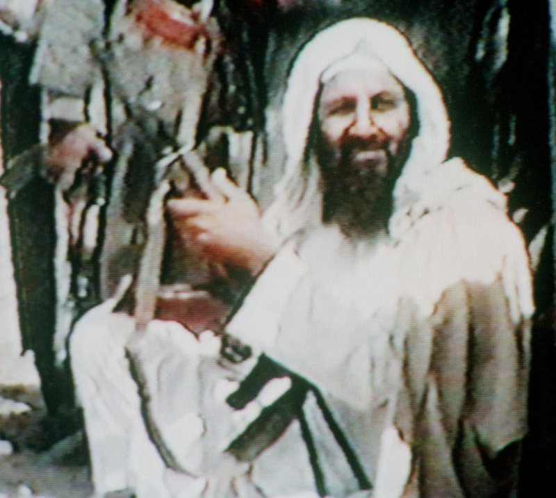 This grainy image shows Osama bin Laden holding an AK-47 assault rifle in an undated recruitment videotape for his organization dating back to at least 2001. The compound where he died was austere, lacking phones and the Internet.