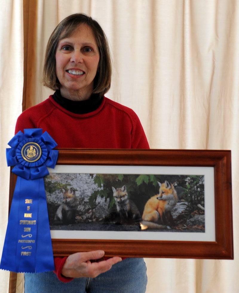 Linda Panzera of Sebago displays "Red, Cutie and Sweetie," which took first place in the "small mammals" class at the Maine Sportsman's Show of wildlife photography.