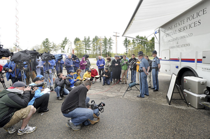 A large number of media representatives attend a news conference with Maine state police Col. Robert Williams and Lt. Bryan McDonough outside a mobile command post in Berwick on Monday. Police are seeking the public's help in identifying a boy whose body was found Saturday in South Berwick.