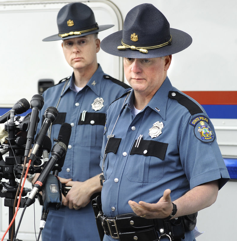 Col. Robert Williams, left, chief of the Maine State Police, and state police Lt. Brian McDonough give the media an update Monday afternoon outside a mobile command post in Berwick.