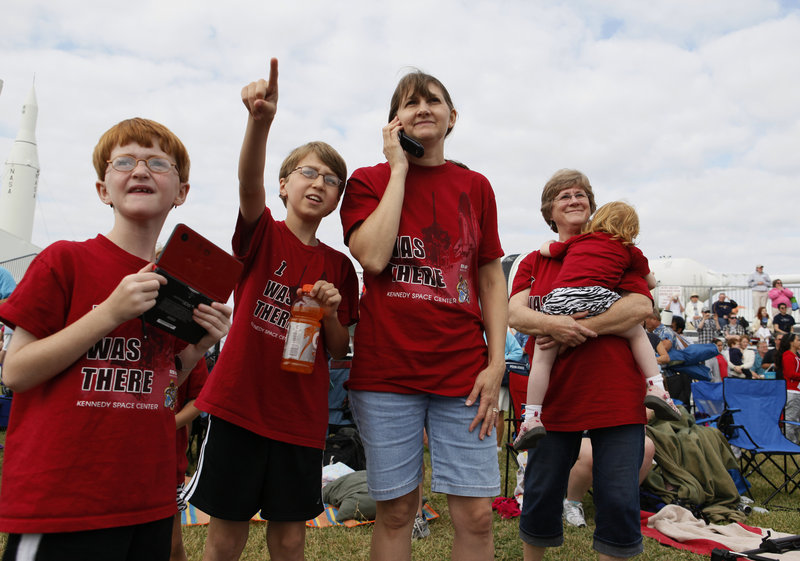 Adam Wheeler, 8, Ryan Wheeler, 11, Debbie Wheeler and Pegy Looten holding Erin Wheeler, all of Bowie, Md., watch the space shuttle from the Kennedy Space Center Visitors Complex in Cape Canaveral, Fla., on Monday.