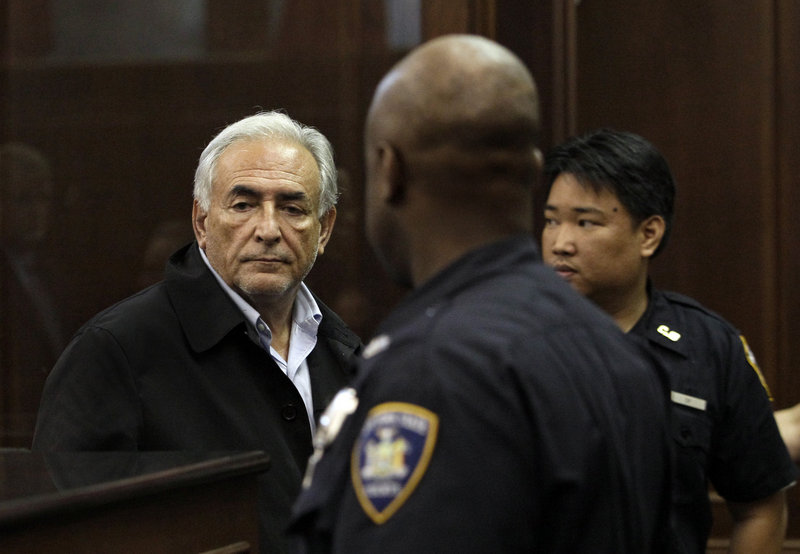 Dominique Strauss-Kahn, left, is remanded to custody after bail was denied at his arraignment Monday in Manhattan Criminal Court. He is accused of attacking a hotel maid who had gone in to clean his penthouse suite Saturday.