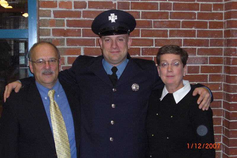 Mary Corbin, right, with her husband, John, and son Joshua at his fire department drill school graduation.