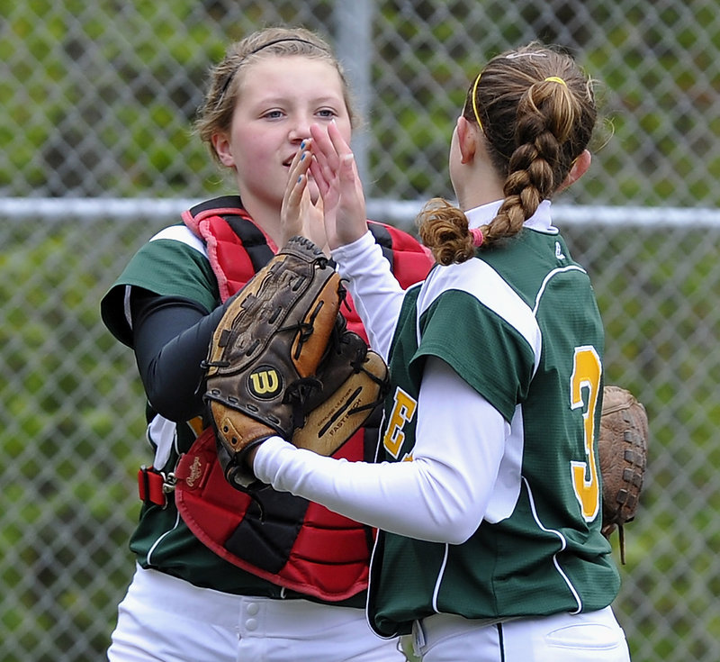 McAuley catcher Sam Schildroth exchanges a high-five with pitcher Jen Field after Field escaped a bases-loaded jam Monday against Gorham. Field allowed just two hits in a 12-0 victory.