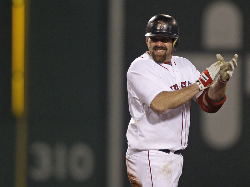 Kevin Youkilis celebrates after hitting a two-run double in the sixth inning Monday night against the Baltimore Orioles. The Red Sox overcame a shaky outing from Daisuke Matsuzaka and earned their fourth straight victory, moving into a tie for second place in the AL East.