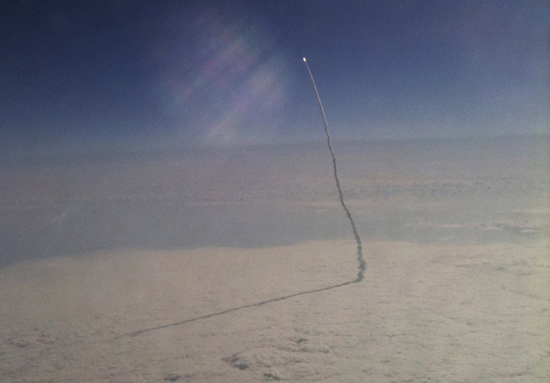 Stefanie Gordon awoke from a nap on her flight from New York to Florida to see the space shuttle Endeavor as it streaked toward orbit after liftoff Monday. The unusual cellphone picture she took also went around the world.