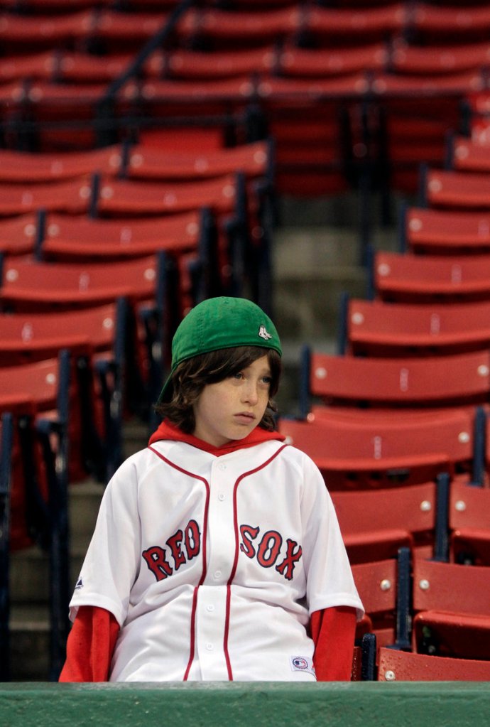 Brooks Fletcher, 9, of Lake Placid, N.Y., hears the bad news: Boston's game against Baltimore at Fenway Park was postponed because of rain.