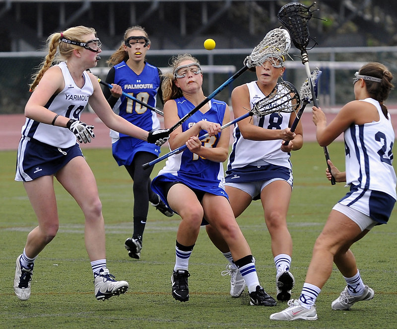 Alex Bernier, who had five goals for Falmouth, is surrounded by Yarmouth defenders, including Caitlin Crawford, left, Devin Simsarian, 18, and Danielle Torres as Geneva Waite of Falmouth moves in Tuesday. Yarmouth won, 13-12.