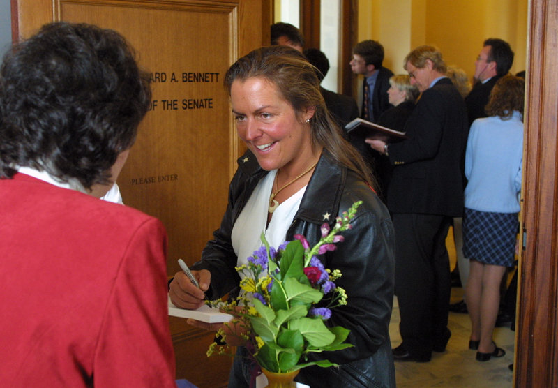 Zoe Zanidakis signs an autograph during a visit to the State House in 2002, when she was saluted by the Legislature after being the first contestant from Maine on “Survivor.”