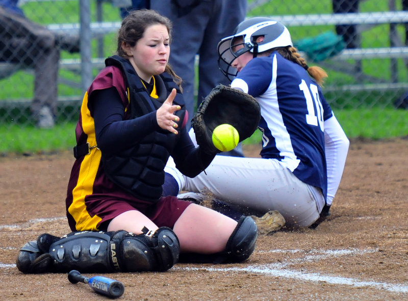 Abbie Hutchinson of Yarmouth finds the plate with a slide, scoring on a first-inning single by McKenzie Gray as Cape Elizabeth catcher Lauren Nicholson takes the throw Wednesday. Yarmouth beat the Capers for the second time in a week, 3-1.