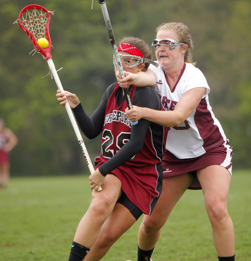 Alex Mitch of Freeport, left, looks for room to advance against Alicia Roost of Greely during Greely's 7-6 victory Thursday in girls' lacrosse at Cumberland.
