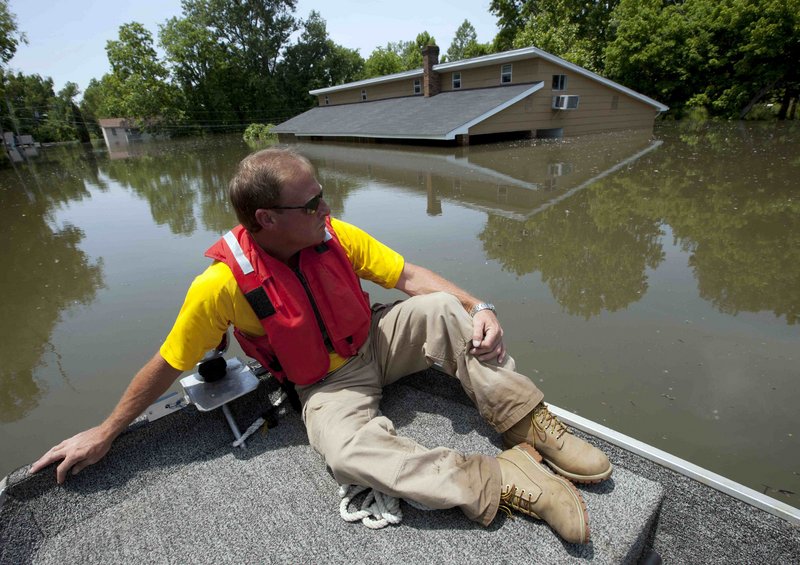 Deputy Mike Traxler views the rooftops of flooded homes in Vicksburg, Miss., Wednesday. Worries eased as floodwaters from the Mississippi River crested at Vicksburg Thursday at a slightly lower level than expected.