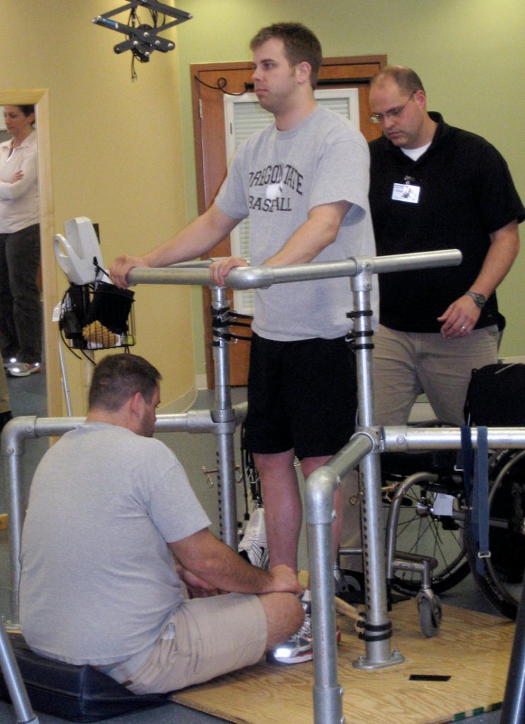 Rob Summers, paralyzed below the waist, undergoes intensive physical therapy in Louisville, Ky. in 2010.