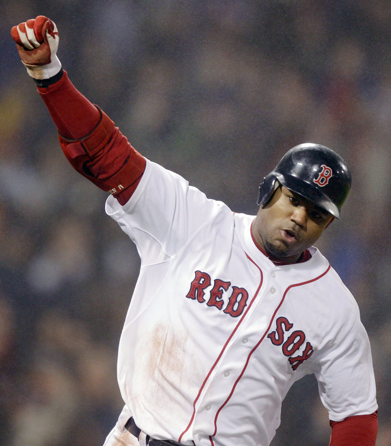 Carl Crawford pumps his fist Thursday night after hitting the bases-loaded single in the ninth inning that gave the Boston Red Sox a 4-3 victory against the Detroit Tigers.