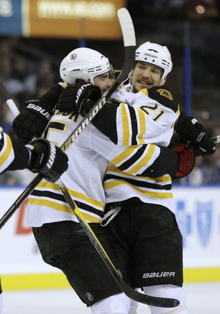 Andrew Ference, right, hugs Johnny Boychuk after scoring Thursday night for the Bruins in the third period of the 2-0 victory over Tampa Bay. Boston holds a 2-1 lead in the series.