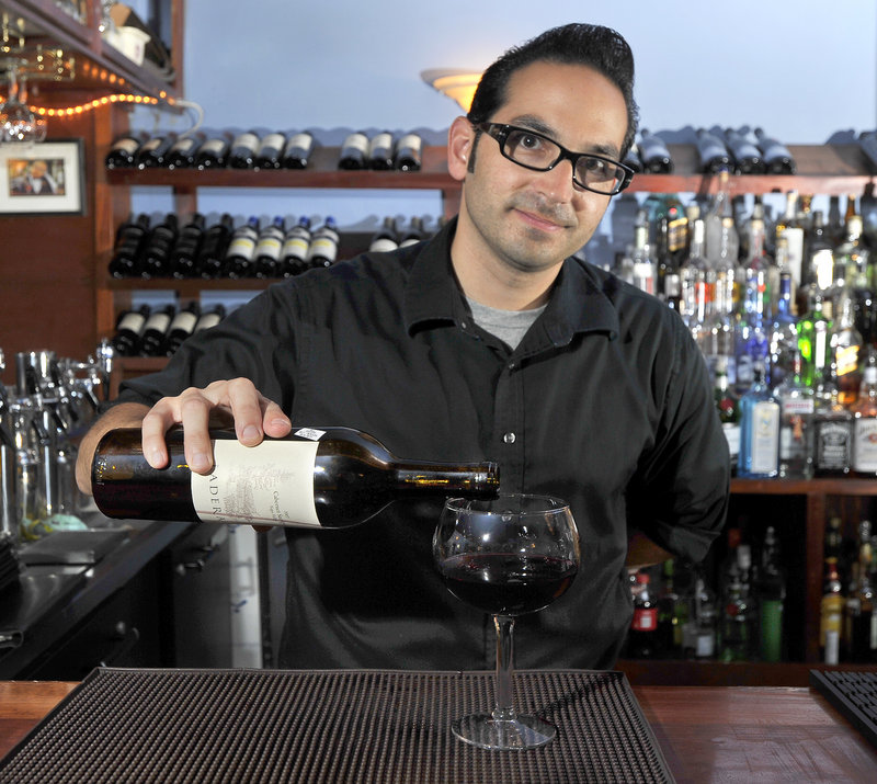 Conundrum Wine Bistro owner Vincent Migliaccio pours a glass of Ladera Cabernet, one of among 250 varieties he keeps on hand – some so rare that the cost runs more than $1,500 a bottle.